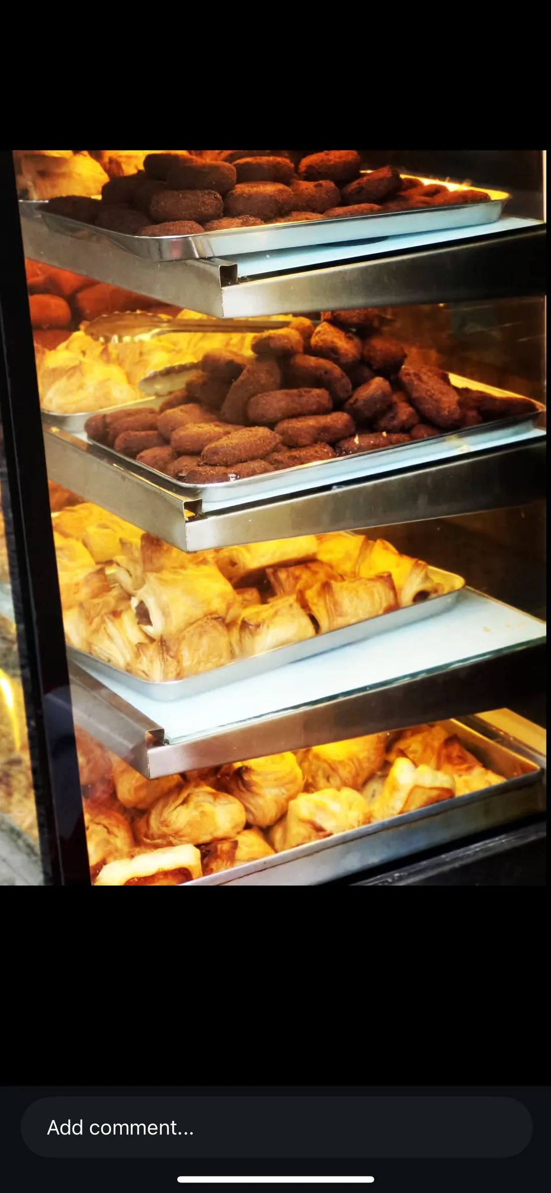 Trays of bakery snacks and puffs in Sajan Bakery’s display